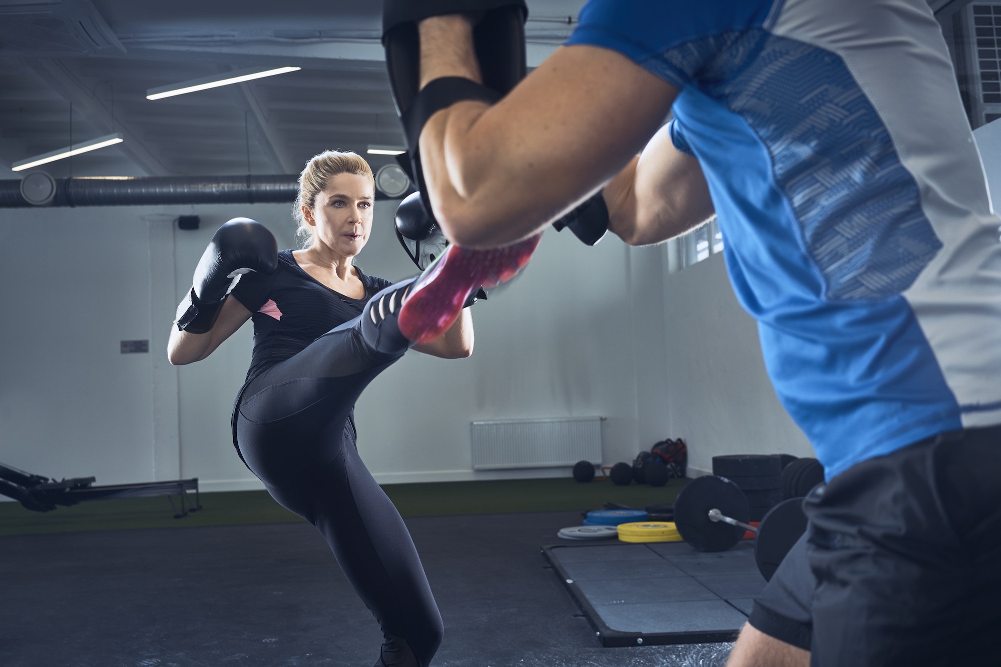 Woman practicing kickboxing at gym